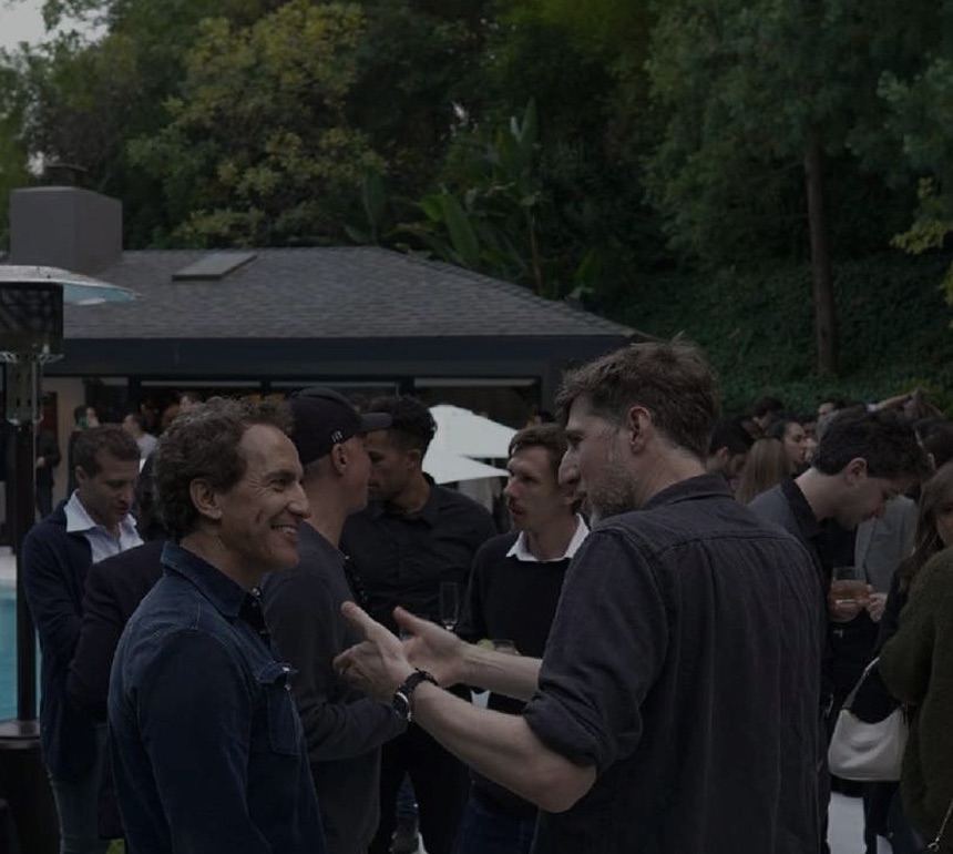 Members in conversation at an evening gathering