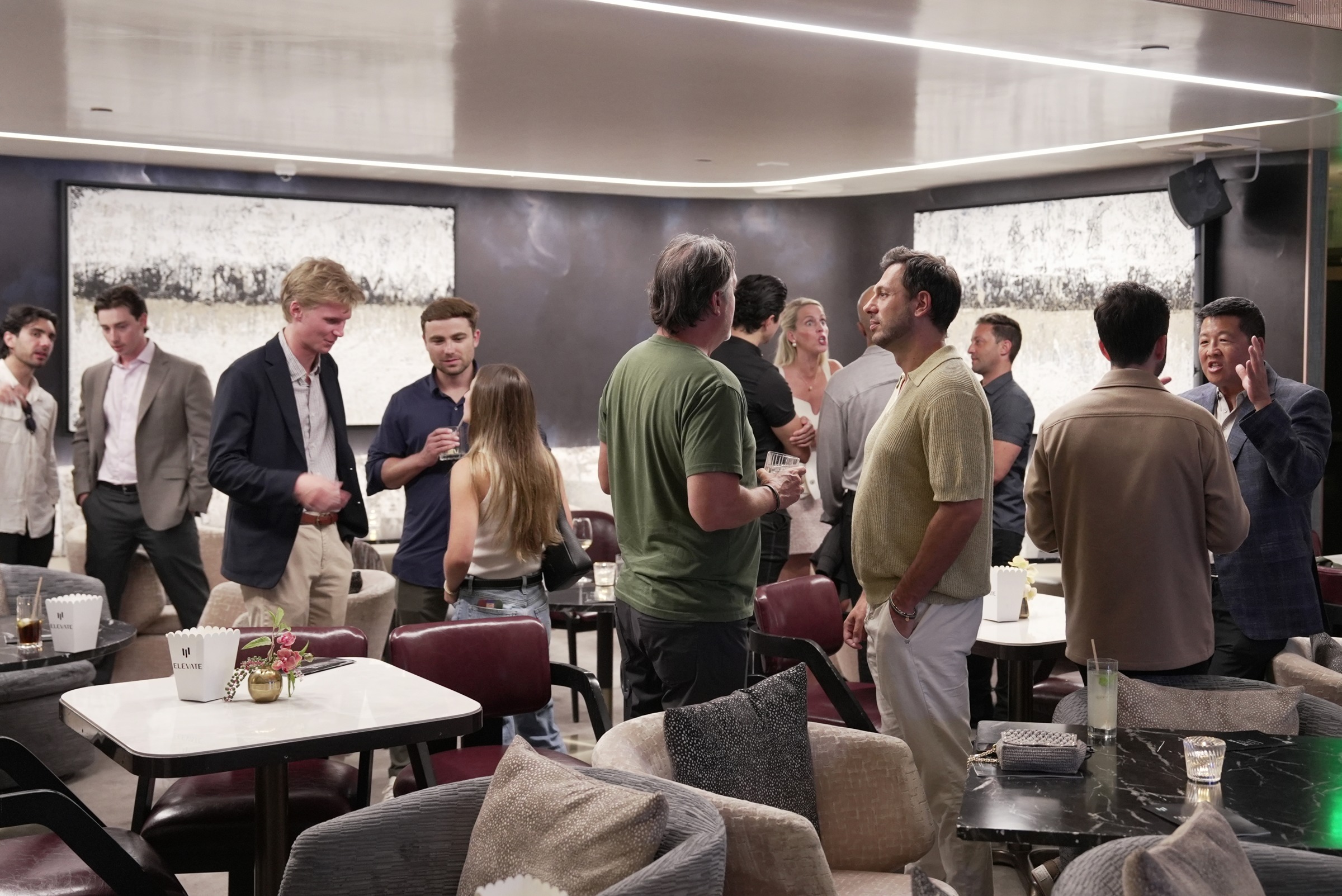 Members in conversation at a private evening gathering